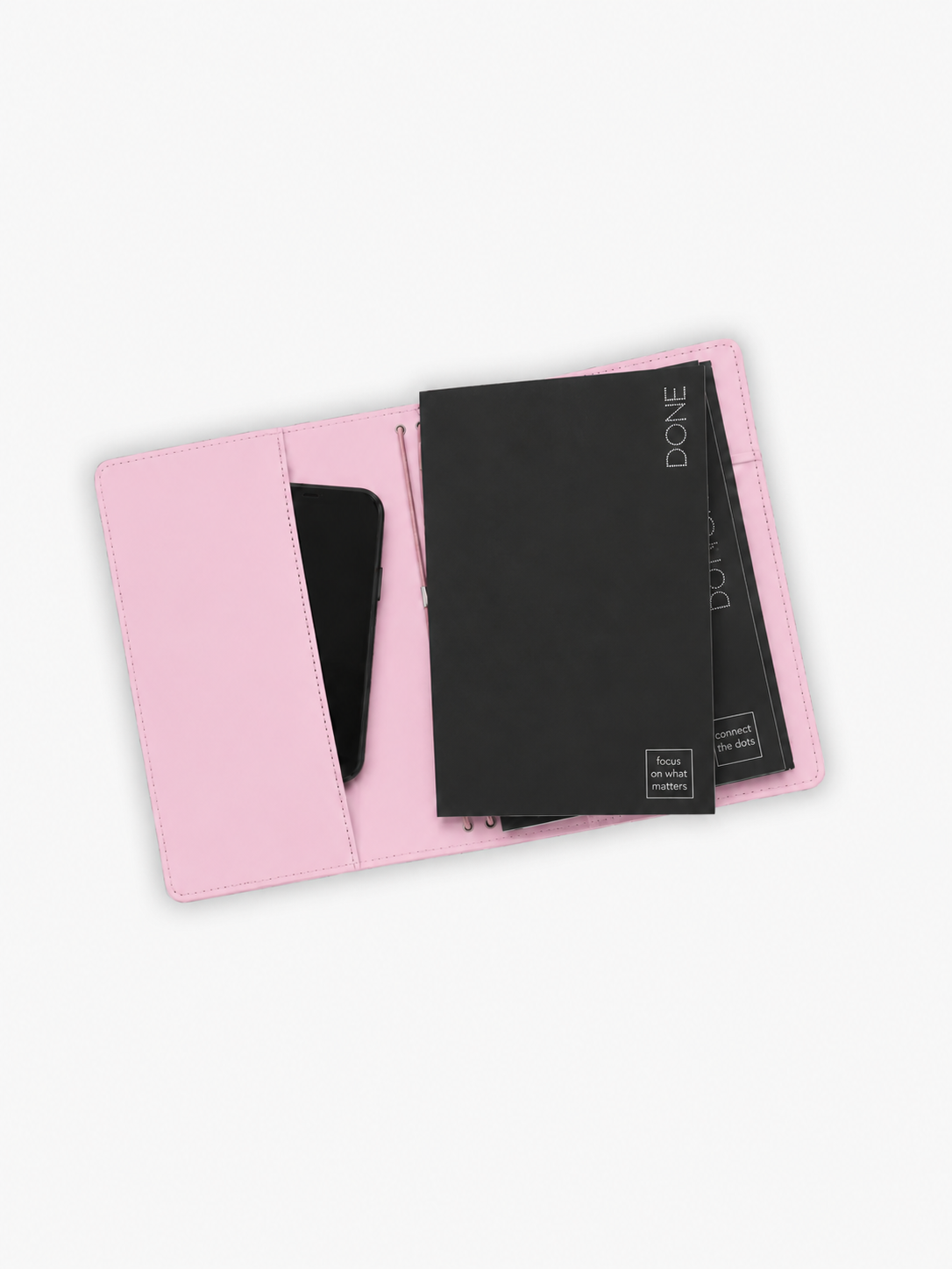 A light pink leather organizer pouch shown open, containing a black notebook and a black smartphone, on a plain white background.